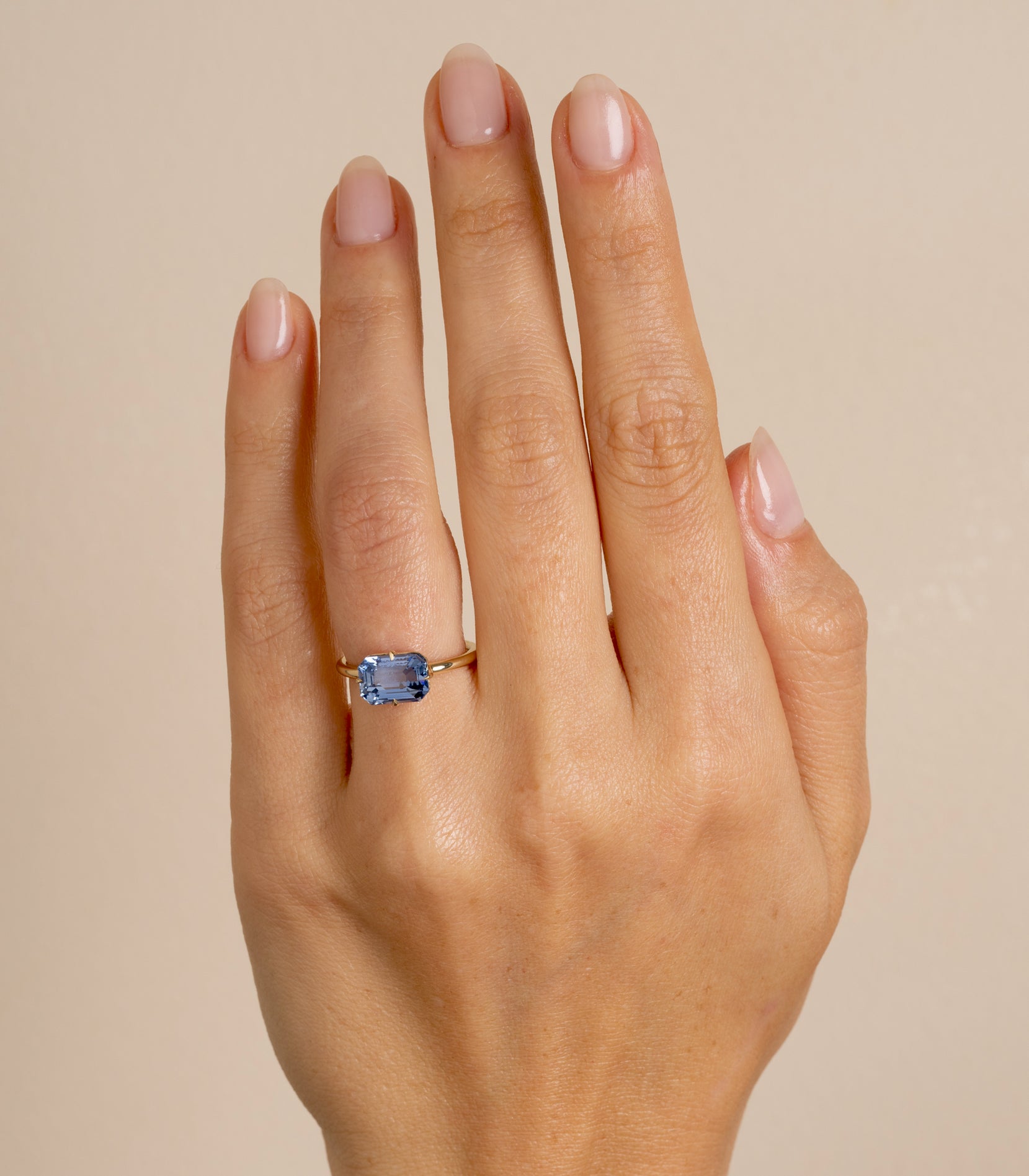 Billie SK-R94-BS-EW-EC-3.00 understated engagement ring in gold with a blue cushion-cut stone