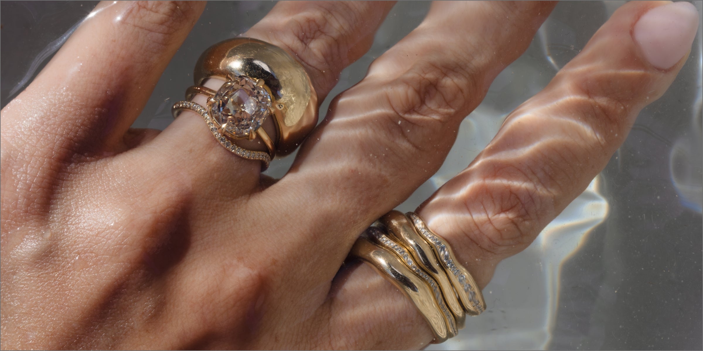 Unique engagement ring on intertwined hands, oval center diamond with halo sparkle and pavé band.