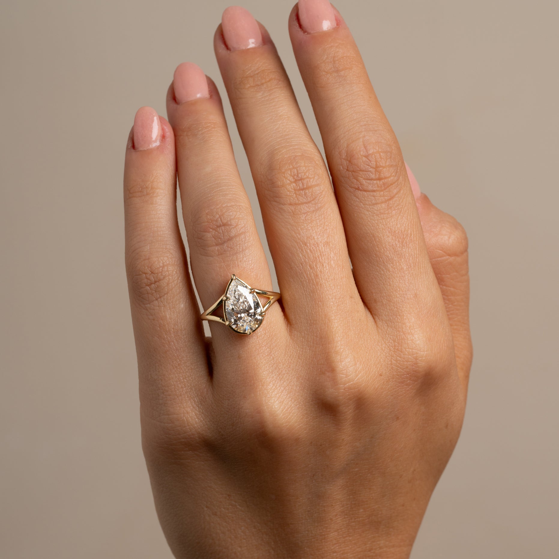 Marlow by SK-R109-LGD-PB-3.05 gold 3 stone engagement ring on hand, pale setting shine