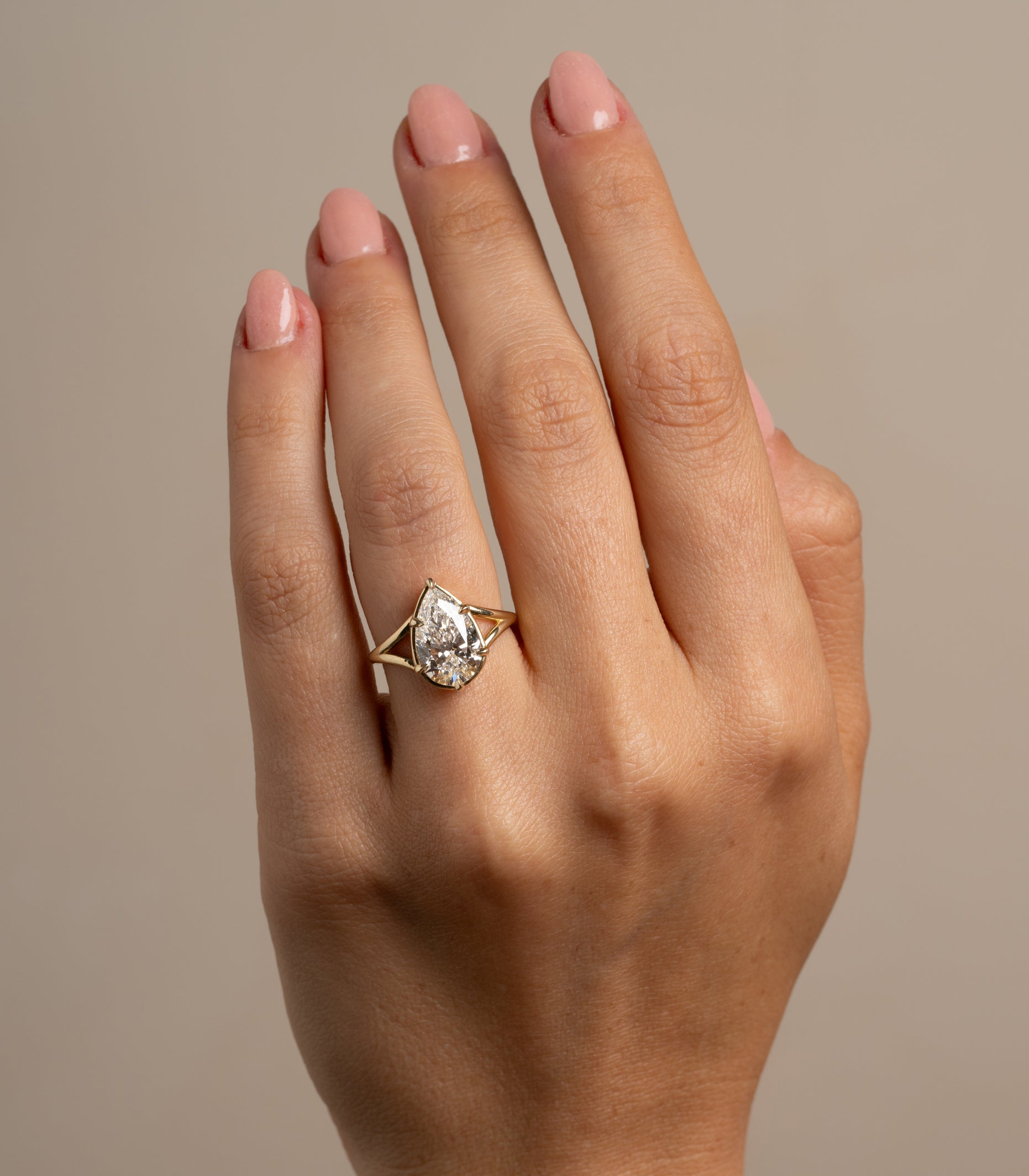 Marlow by SK-R109-LGD-PB-3.05 gold 3 stone engagement ring on hand, pale setting shine