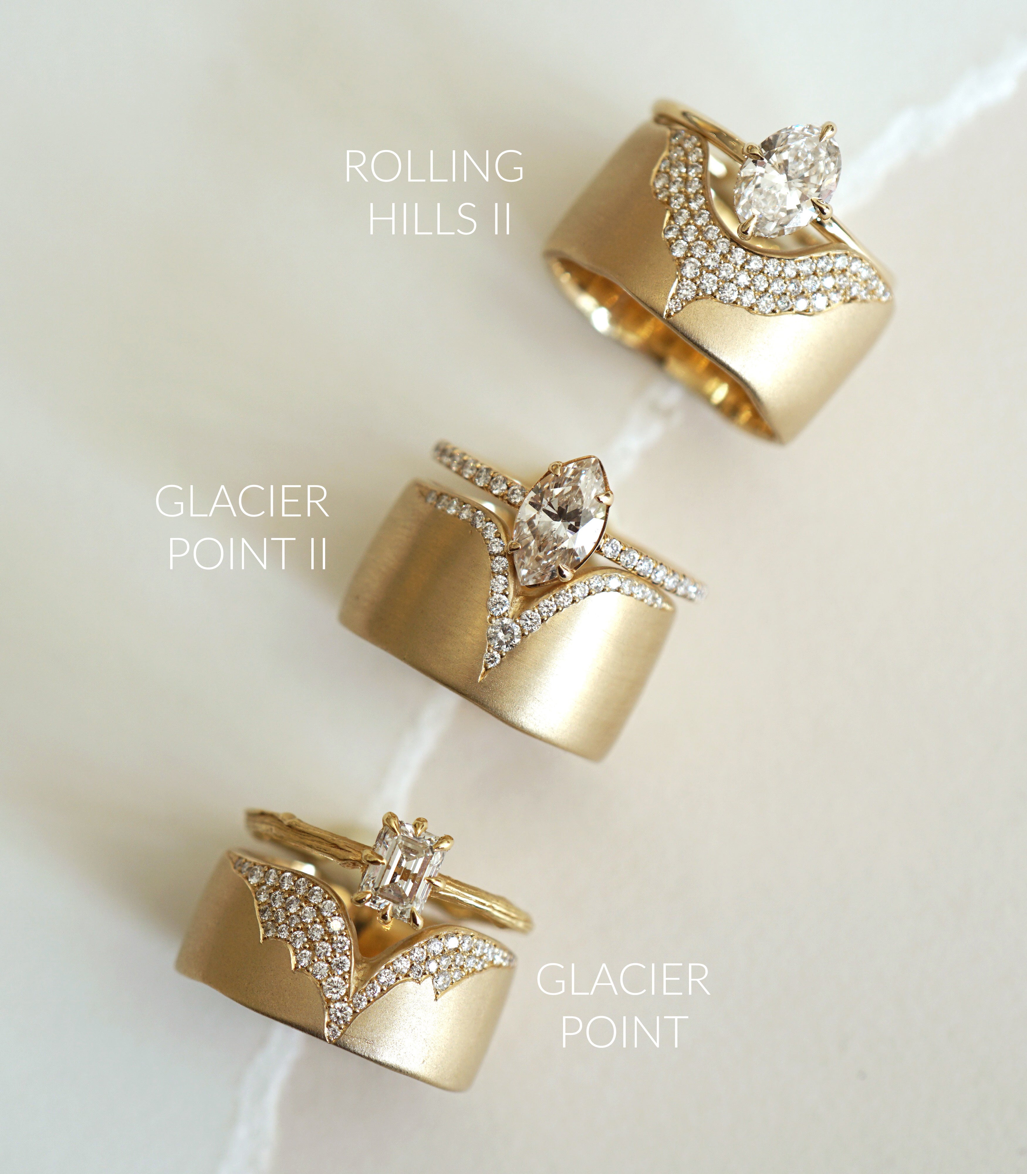 Unique engagement ring with a round diamond center and pavé stones, asymmetrical gold setting on a soft background.