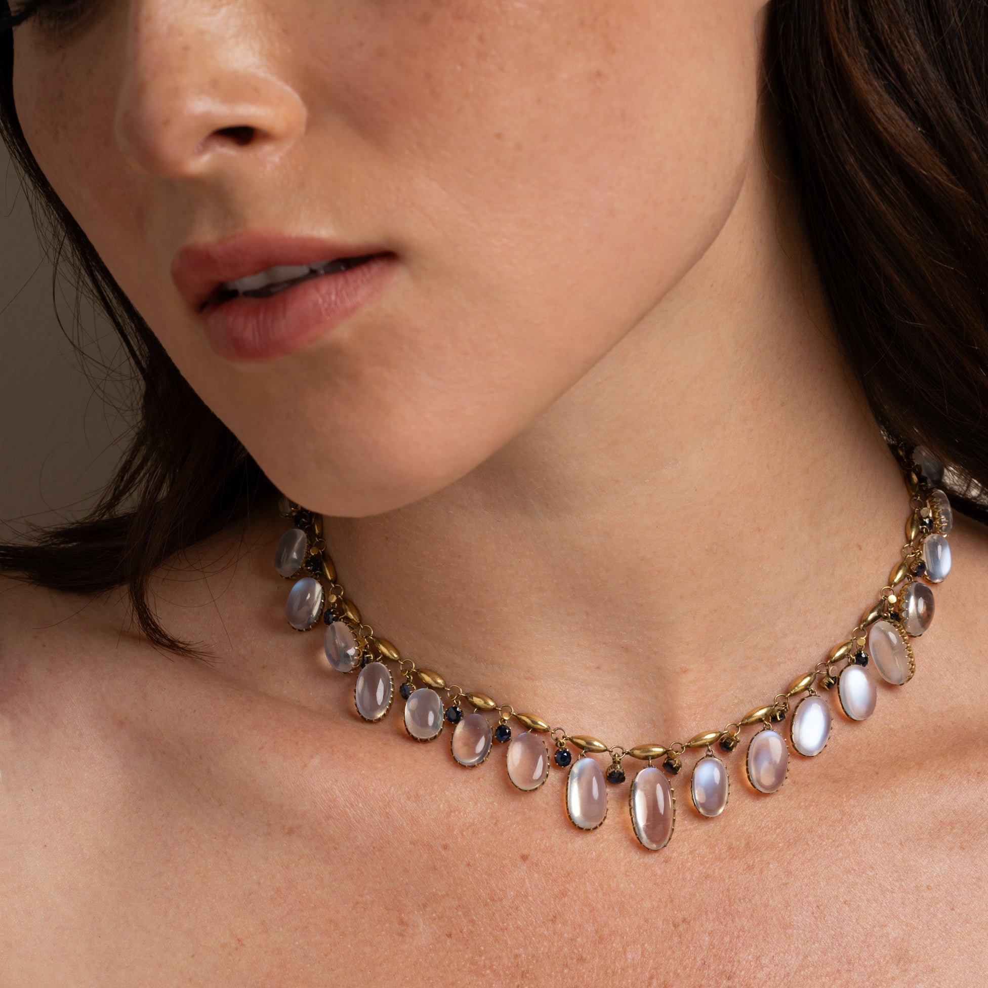 Moon Over Matter by VC-N36 necklace in gold with oval gemstones around the neck, close-up