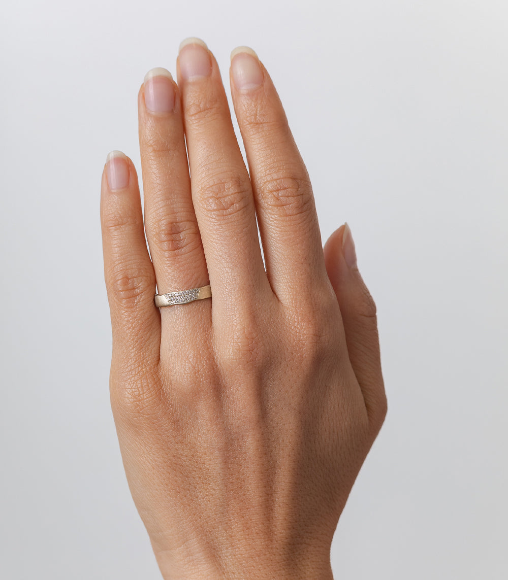 Torn Paper Band P-R2-1spot ring band 14K white gold shiny torn-paper texture on finger.