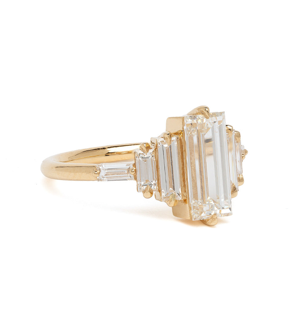 Ingrid SK-R100-ND-1.50 gold engagement ring with emerald-cut clear stone and baguette details.