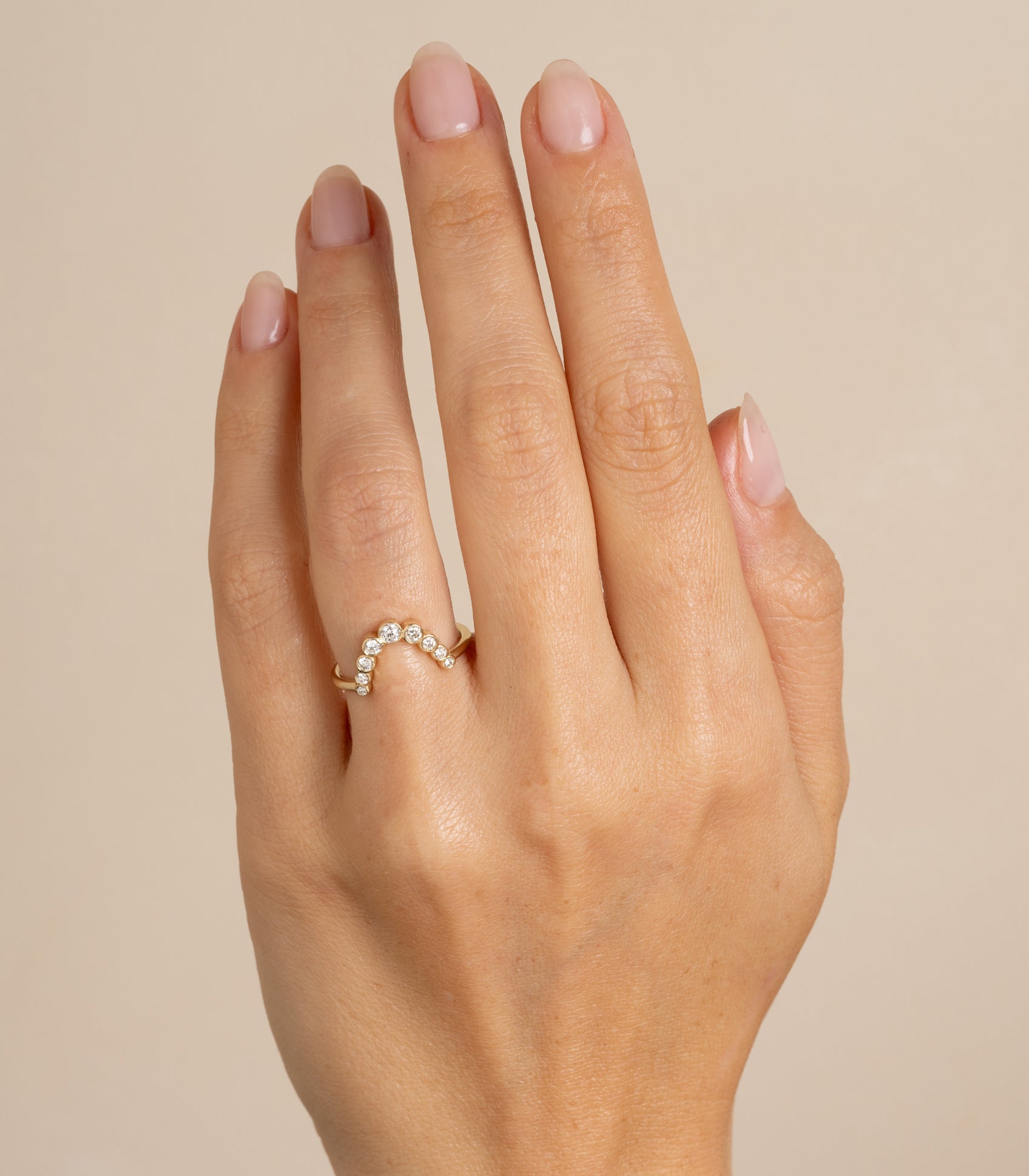 Bezels Sunrise Nesting Band AL-R17 band in 14k yellow gold with bezel-set round stones on finger