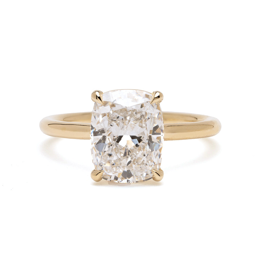 Billie Sofia Kaman engagement ring in gold with cushion-cut diamond center, prong setting