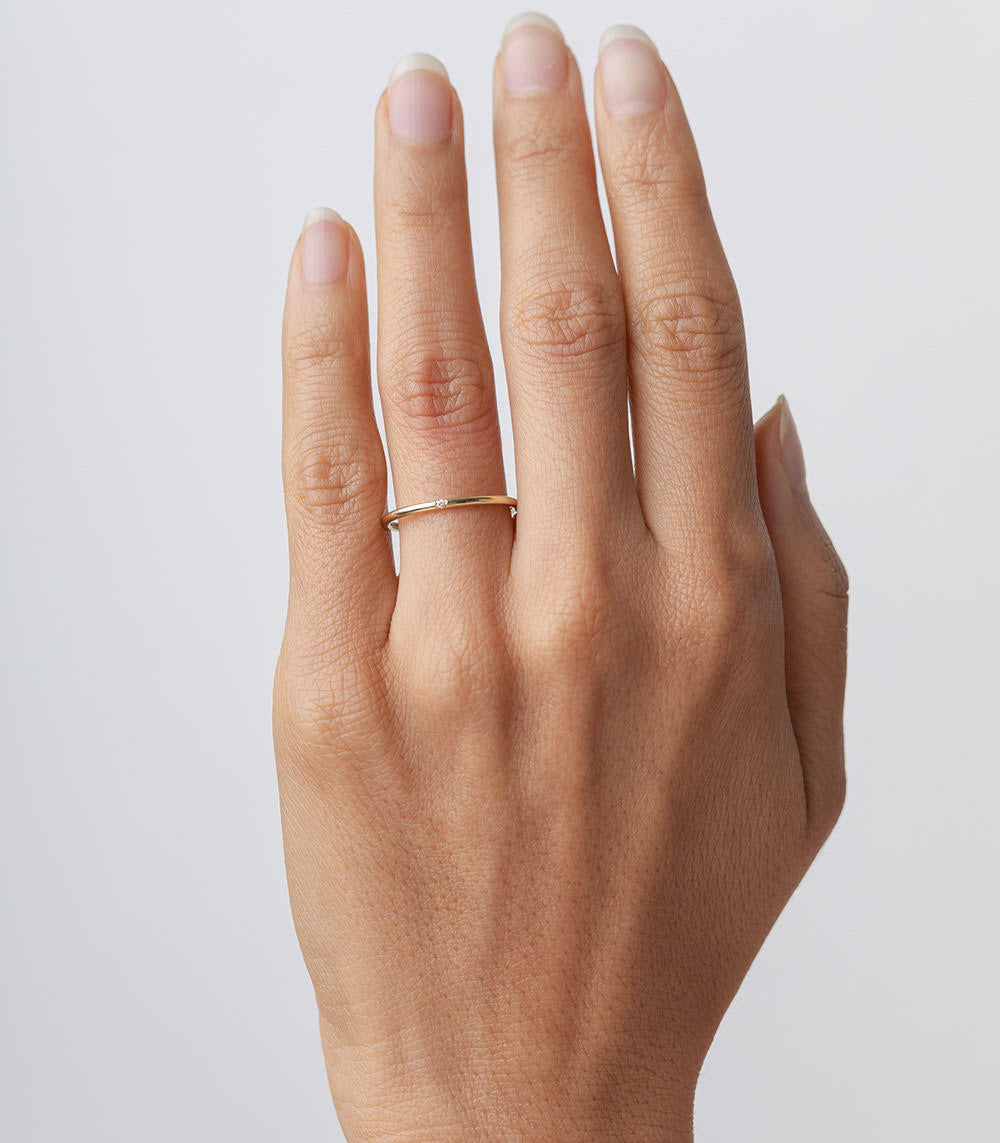 Classic Wire Band A-R27 14K Yellow Gold ring with shiny understated thin wire band on a hand