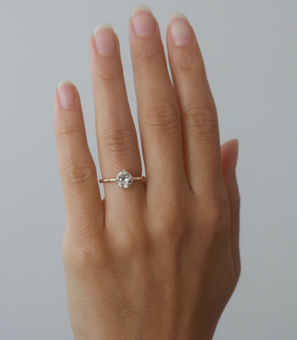 Spiky Crown by EL-R18-OEC-WD-MD yellow gold engagement ring with round diamond solitaire on finger