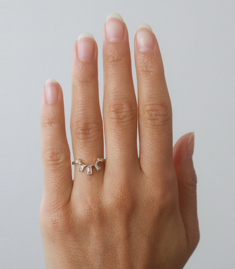 Sunrise Nesting Band by A-R23-L, 14K yellow gold nesting band with shiny finish shown on hand.
