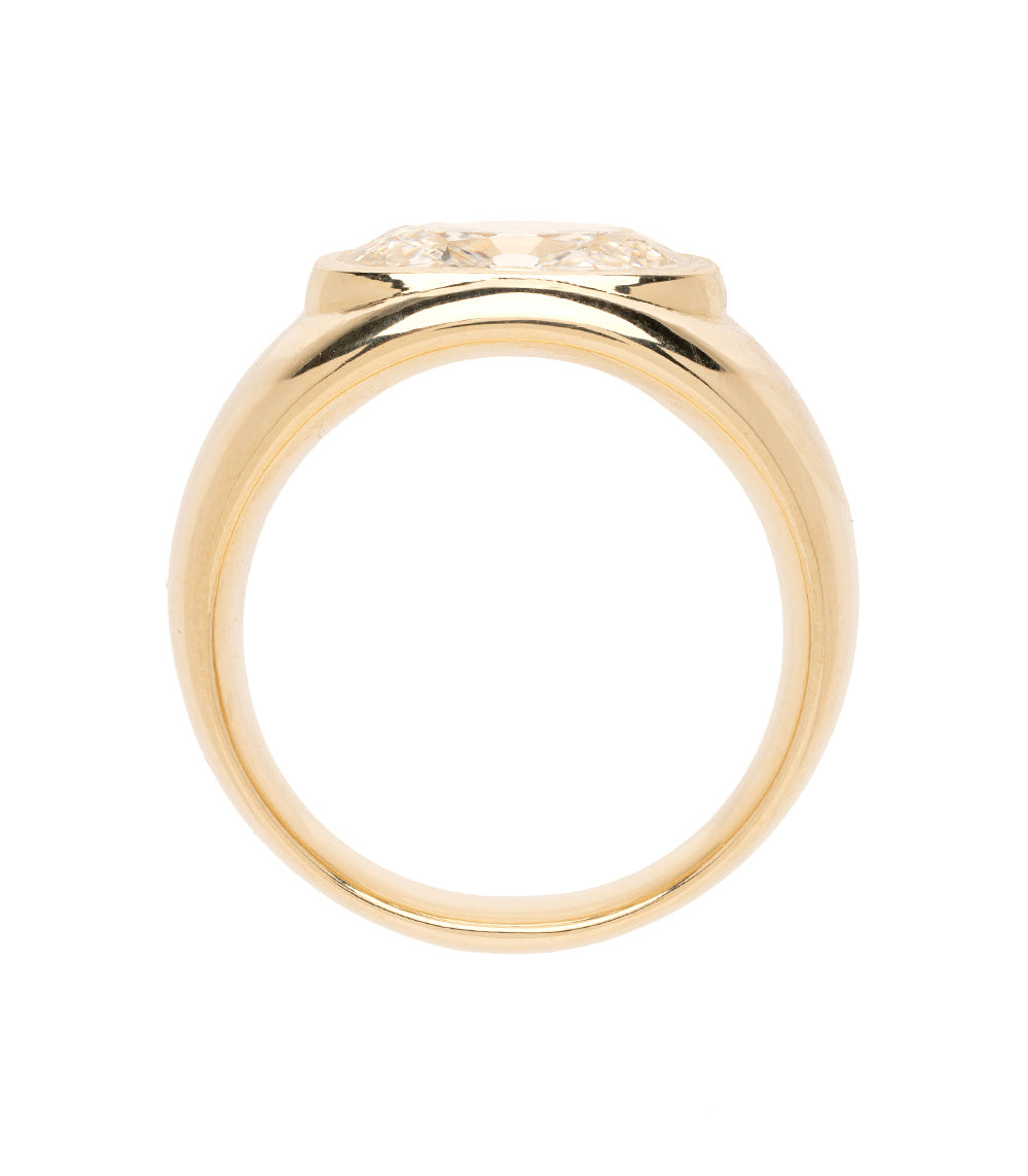 Gold ring with intricate design on a white background