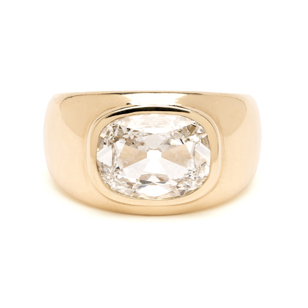 Gold ring with a large diamond on a white background