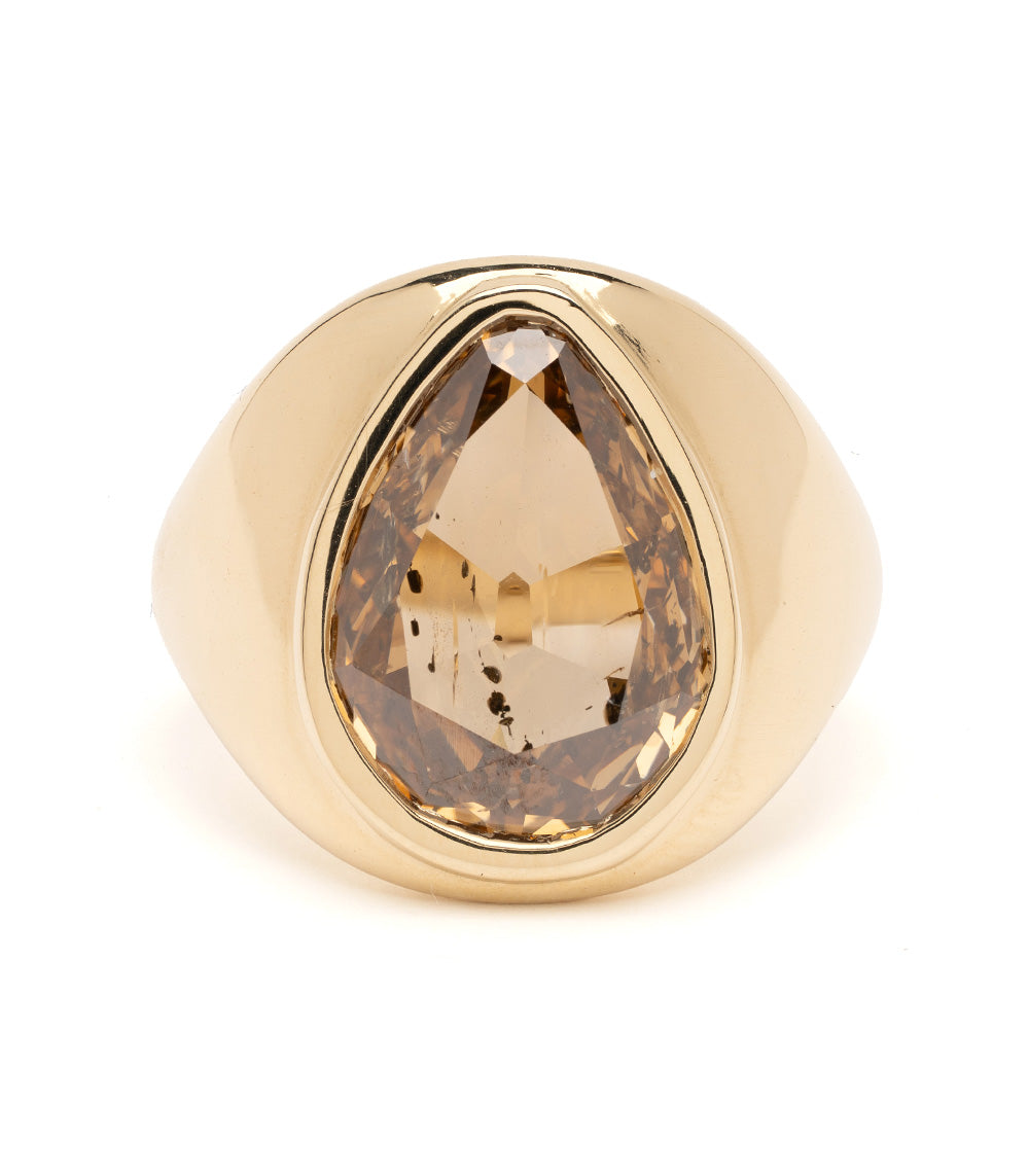 Gold ring with a large brown gemstone on a white background
