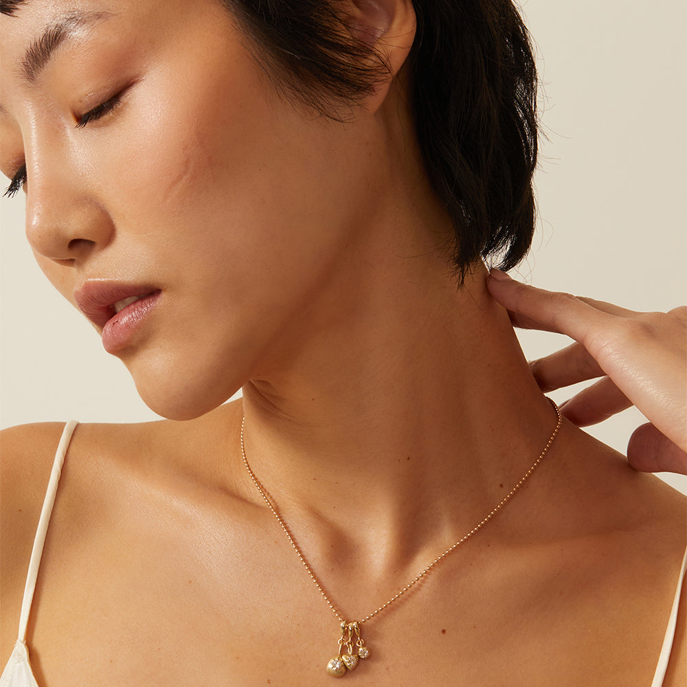Cora Minis Charm Necklace by KM-N12 in gold with mini charm cluster, shiny and matte finish
