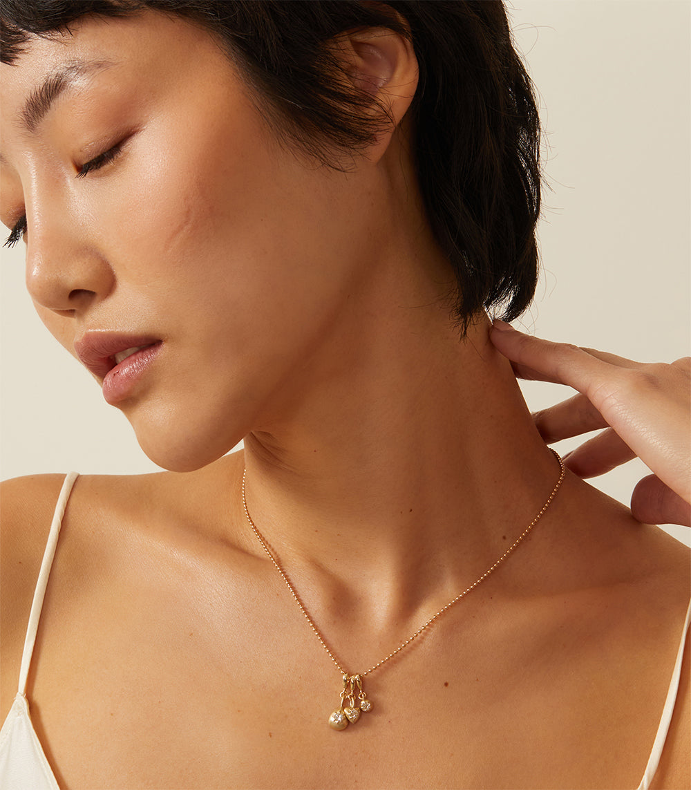 Cora Minis Charm Necklace by KM-N12 in gold with mini charm cluster, shiny and matte finish