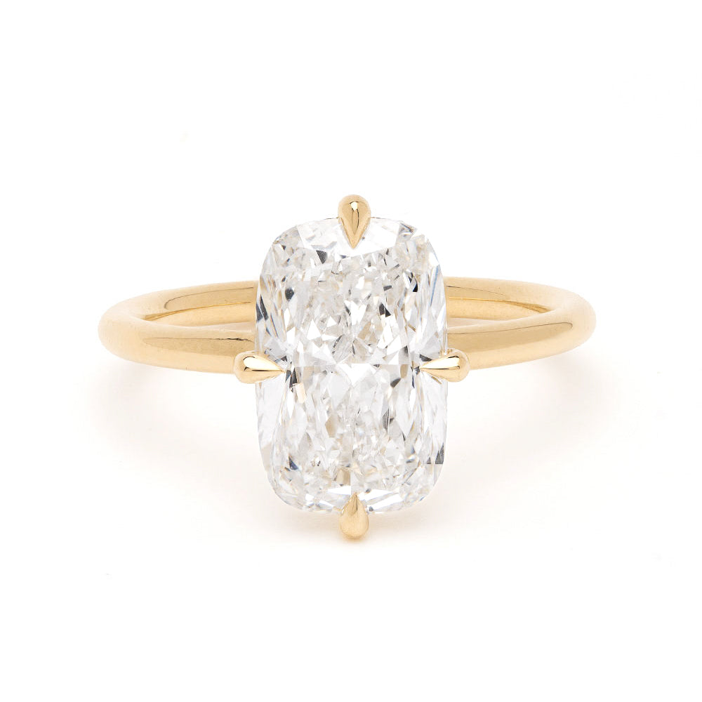 Billie Sofia Kaman unique engagement ring in gold with oval-cut diamond solitaire setting on white background