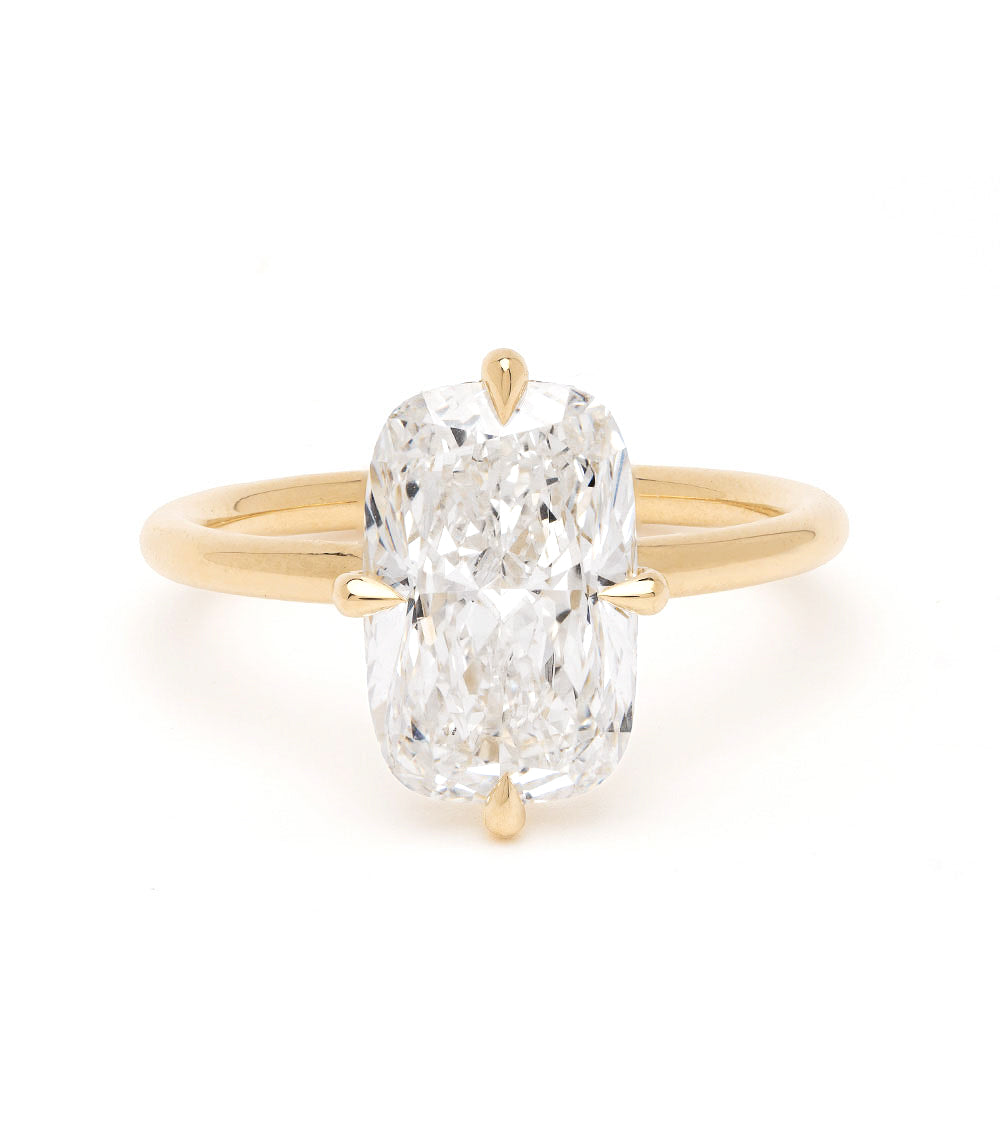 Billie Sofia Kaman unique engagement ring in gold with oval-cut diamond solitaire setting on white background