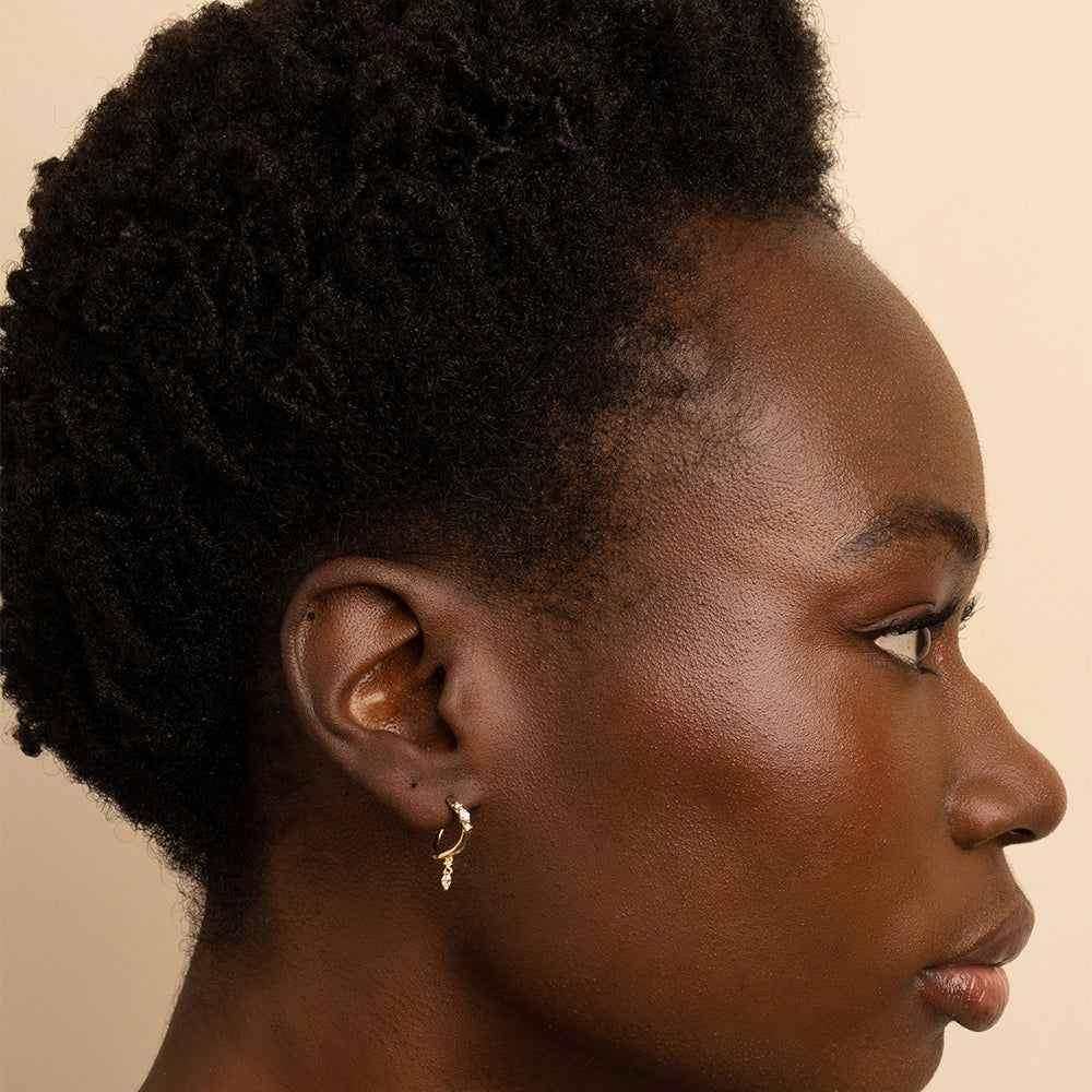 Small Melt Hoops ML-E4 hoop earrings in gold with shiny matte finish on close-up model.