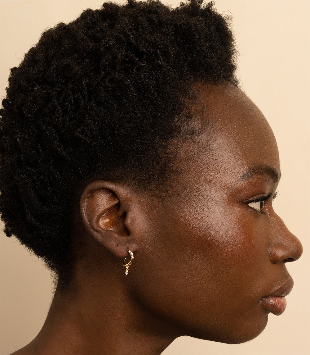 Small Melt Hoops ML-E4 hoop earrings in gold with shiny matte finish on close-up model.