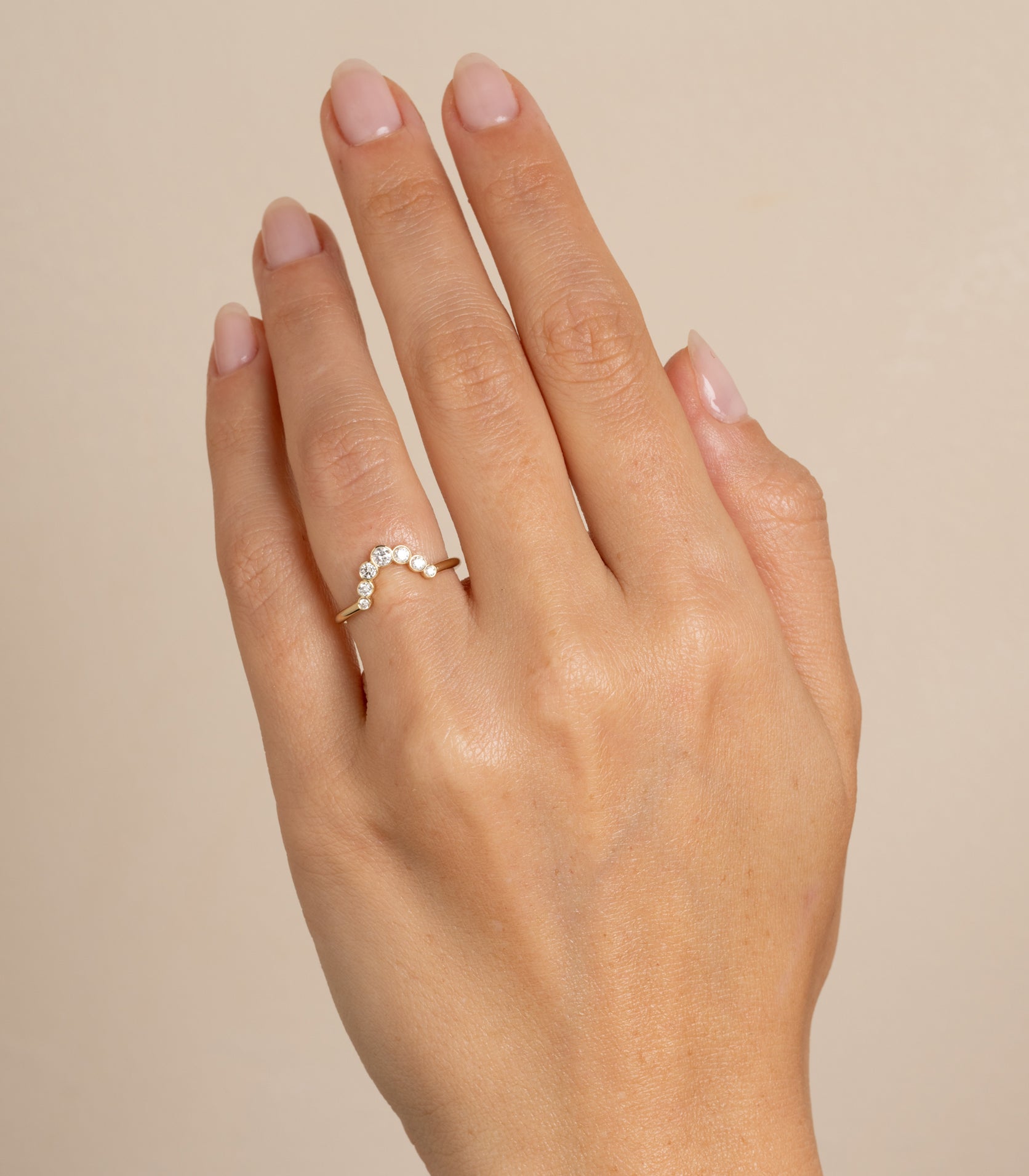 Bezels Sunrise Nesting Band AL-R18 bands in 14K yellow gold with bezel-set round diamonds on finger
