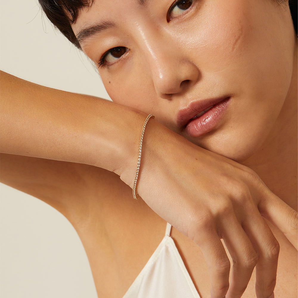 The Hills CC-DB1 bracelet in gold tone, slim tennis-style chain sparkling along the wrist