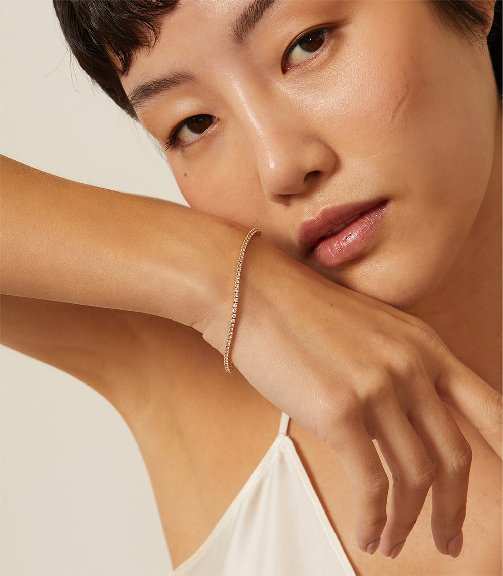 The Hills CC-DB1 bracelet in gold tone, slim tennis-style chain sparkling along the wrist