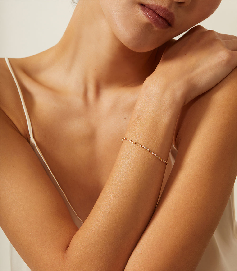 The Melrose CC-DB3 gold bracelet with fine pave stones on a wrist, soft studio lighting