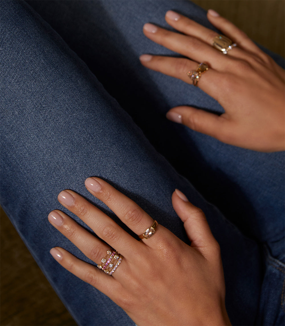 Estée Band SB-R2 gold band rings with shiny yellow gold and sparkling multi-stone design on hands