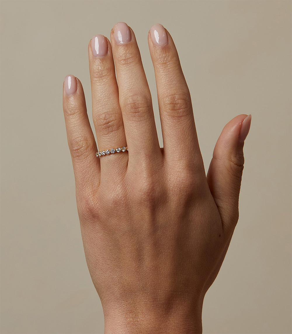 Kissing Diamonds EB-R18 shiny 14K gold engagement ring with a row of small stones on hand