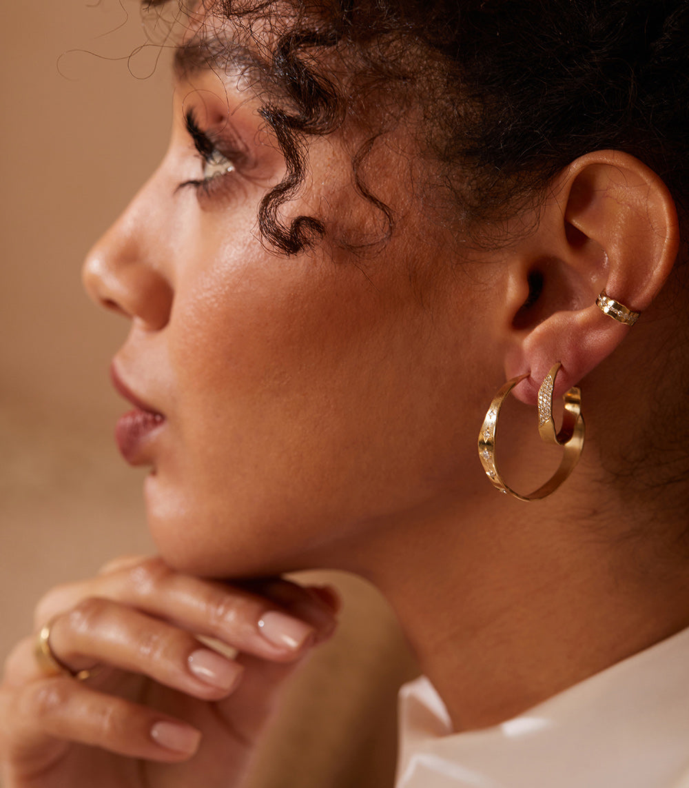Mini Torn Paper Ear Cuff by P-EC1-Line in 14K yellow gold, shiny torn-paper ear cuff on model.