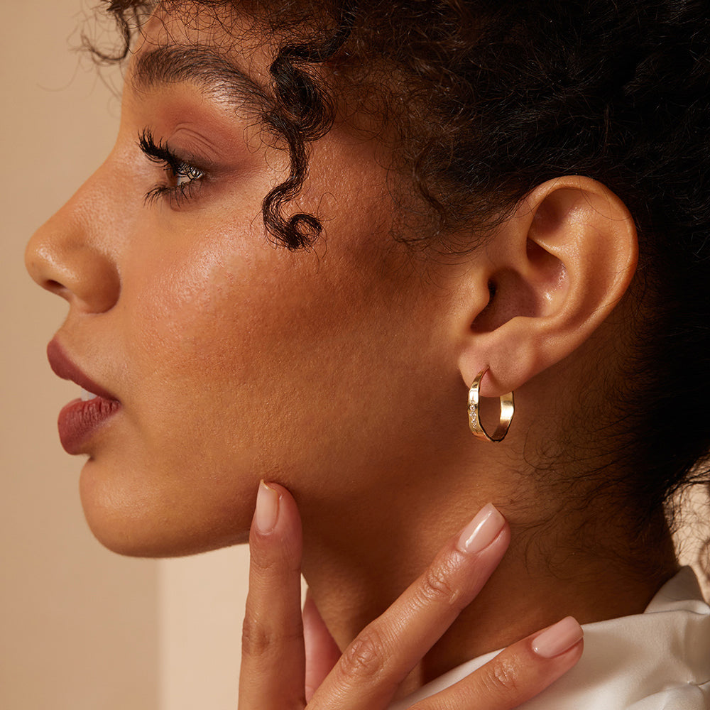 Small Torn Paper Hoops by P-EH3-Vert 14K yellow gold hoop earrings with shiny torn-paper texture