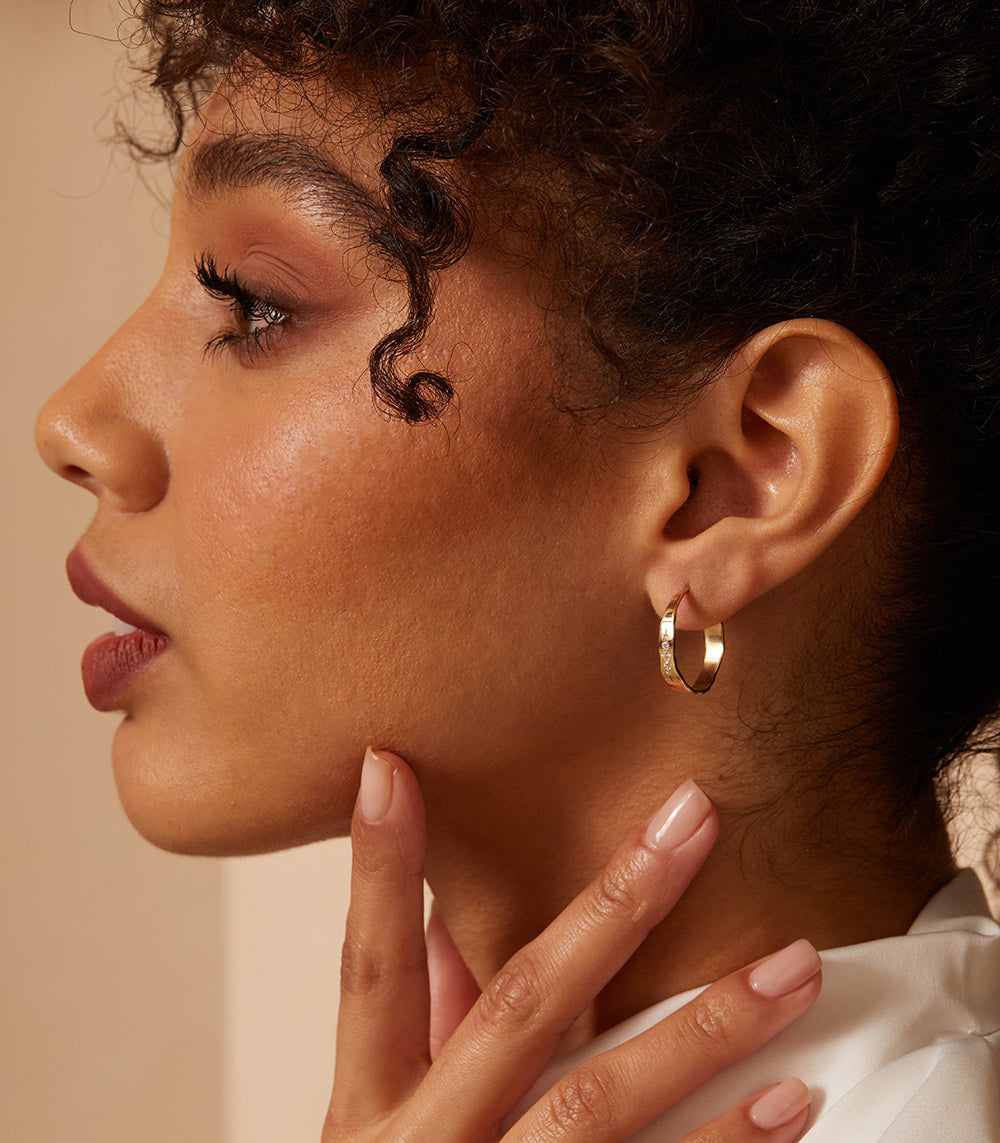 Small Torn Paper Hoops by P-EH3-Vert 14K yellow gold hoop earrings with shiny torn-paper texture