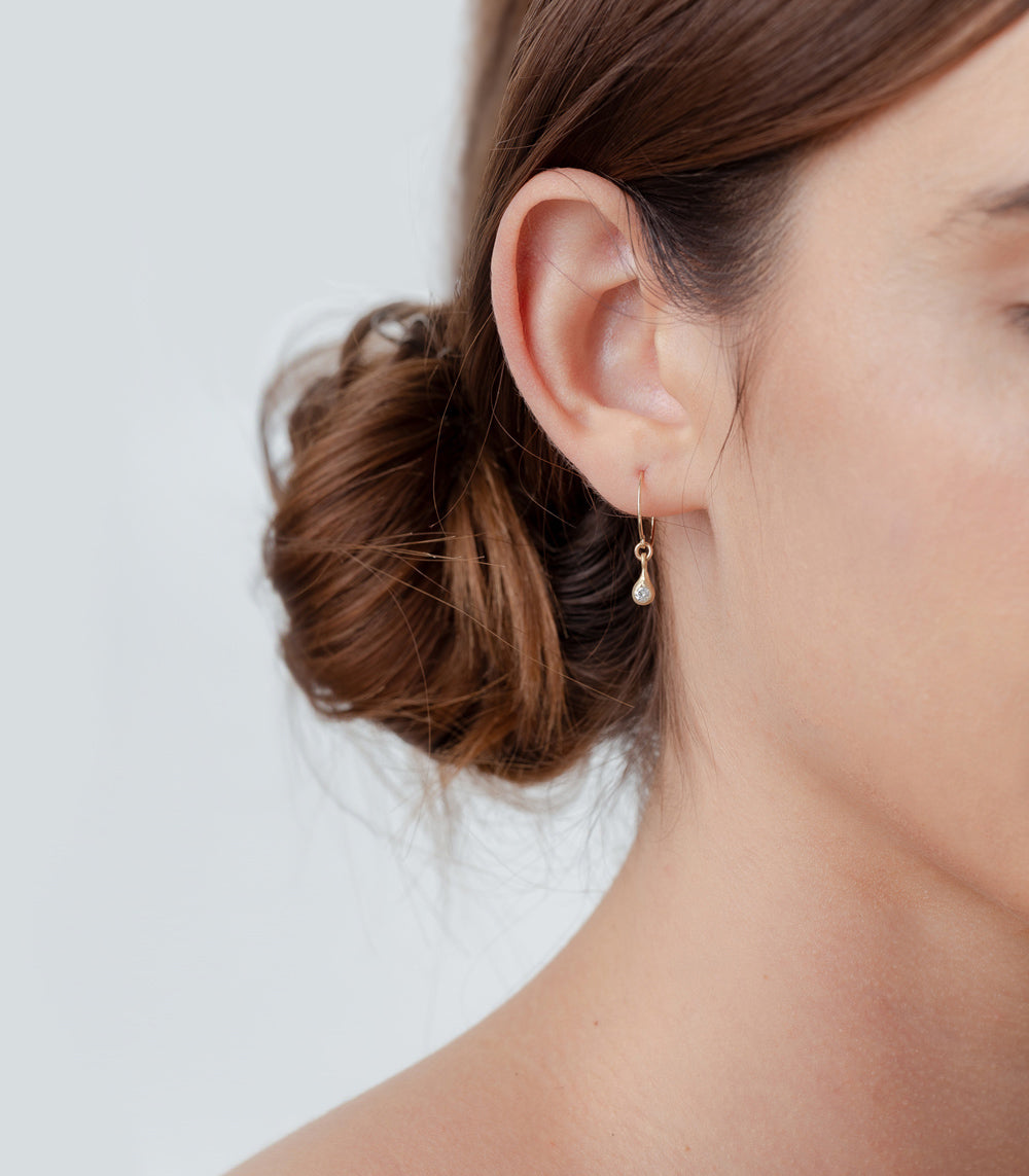 Dewdrop Earrings by T-E20 in shiny gold with teardrop stone, delicate dangling drop design
