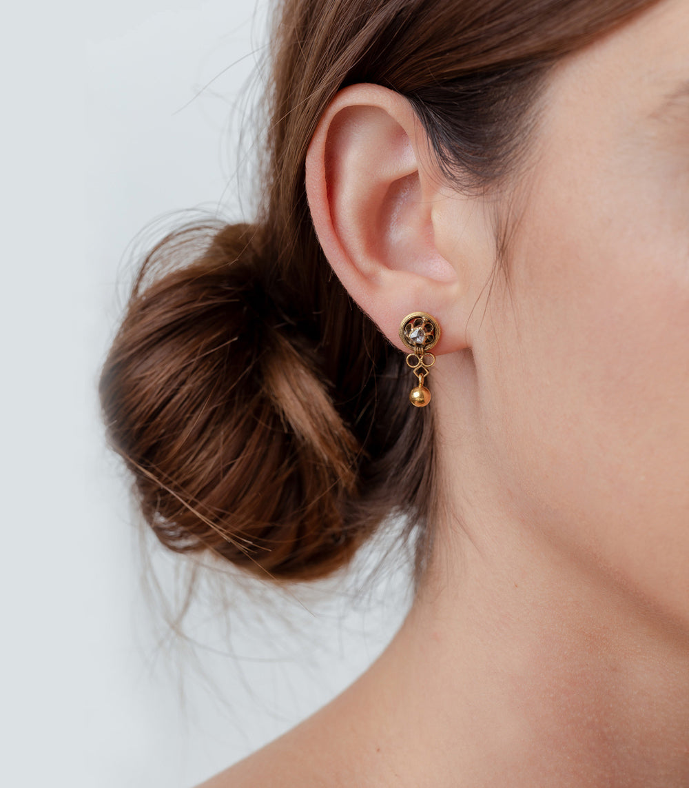 Golden Buttercup Drop Earrings by VC-E15, gold drop earrings with small circular charm and dangling bead.