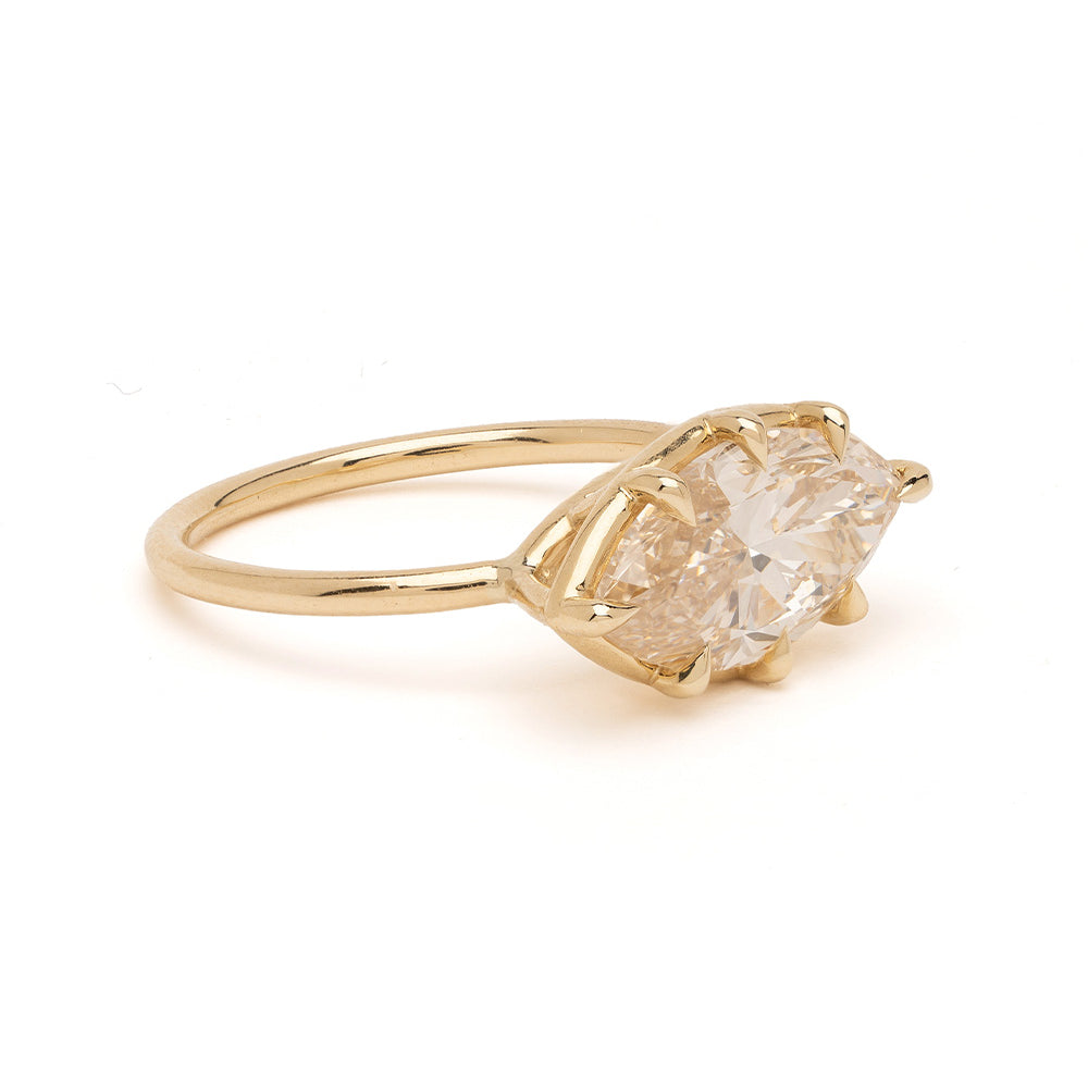 Gigi Sofia Kaman engagement ring in gold with a faceted natural drop diamond setting