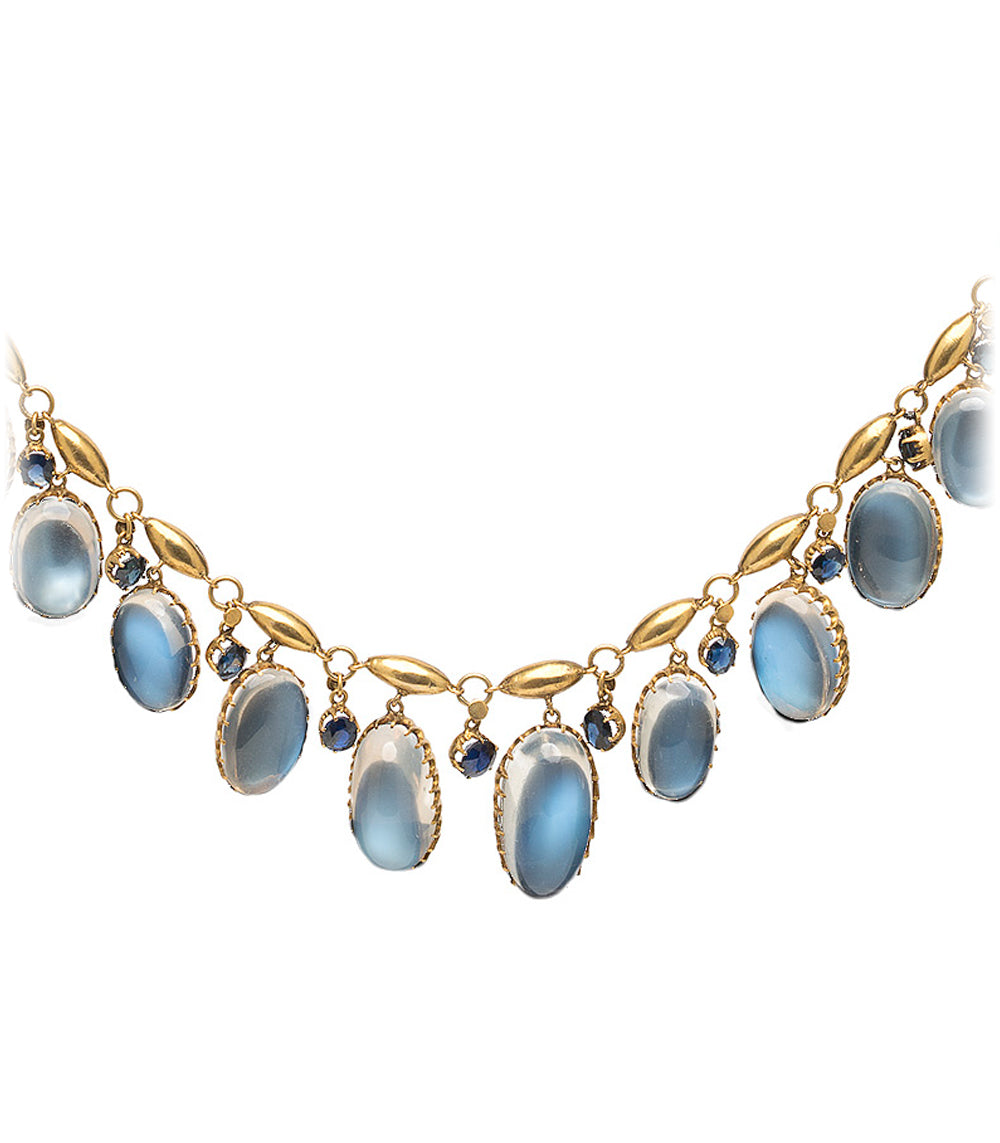 Moon Over Matter by VC-N36 gold necklace with light blue oval stones and dangling leaf accents.
