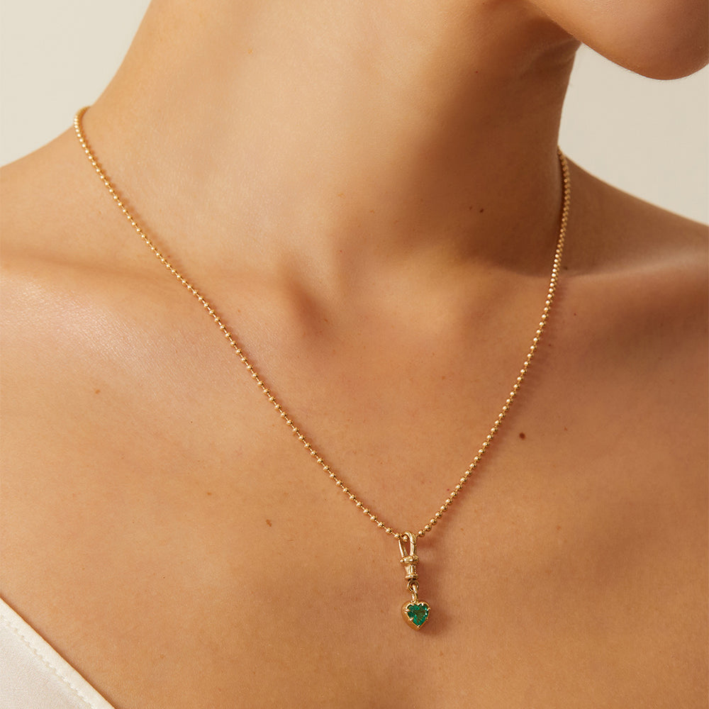 Cora Swivel Pendant KM-P3 gold pendant necklace with green heart charm, fine chain shine on skin