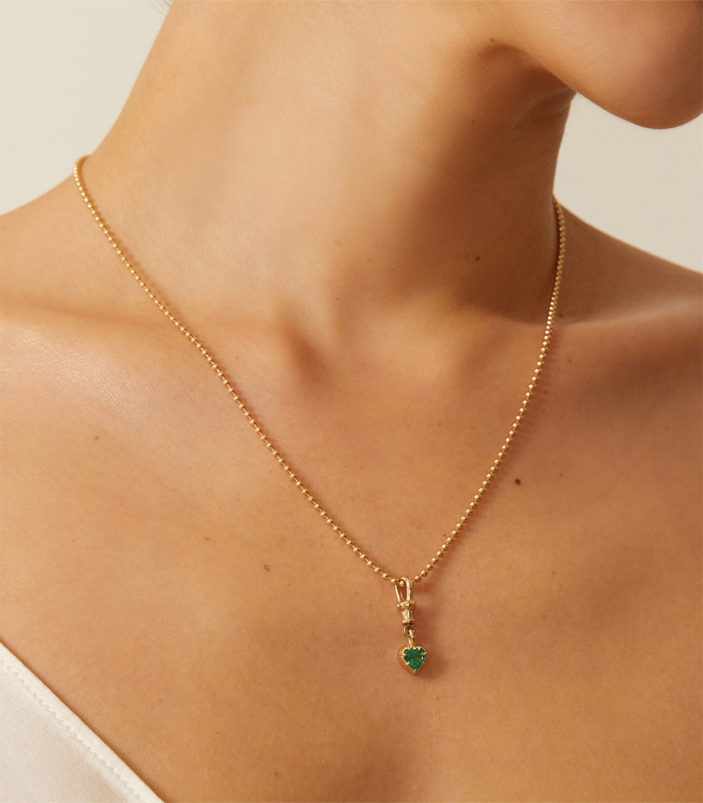 Cora Swivel Pendant KM-P3 gold pendant necklace with green heart charm, fine chain shine on skin