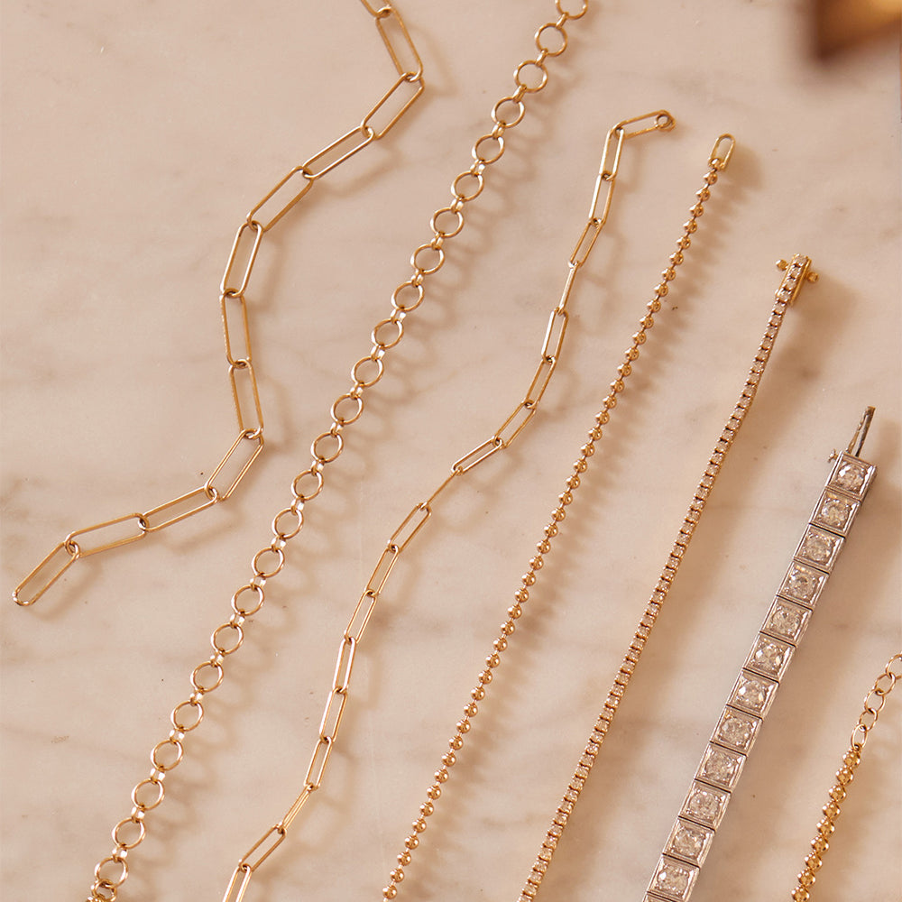 The Loop de Loop Bracelet by CB-C5 in gold with looped chain links and slim bar clasp details