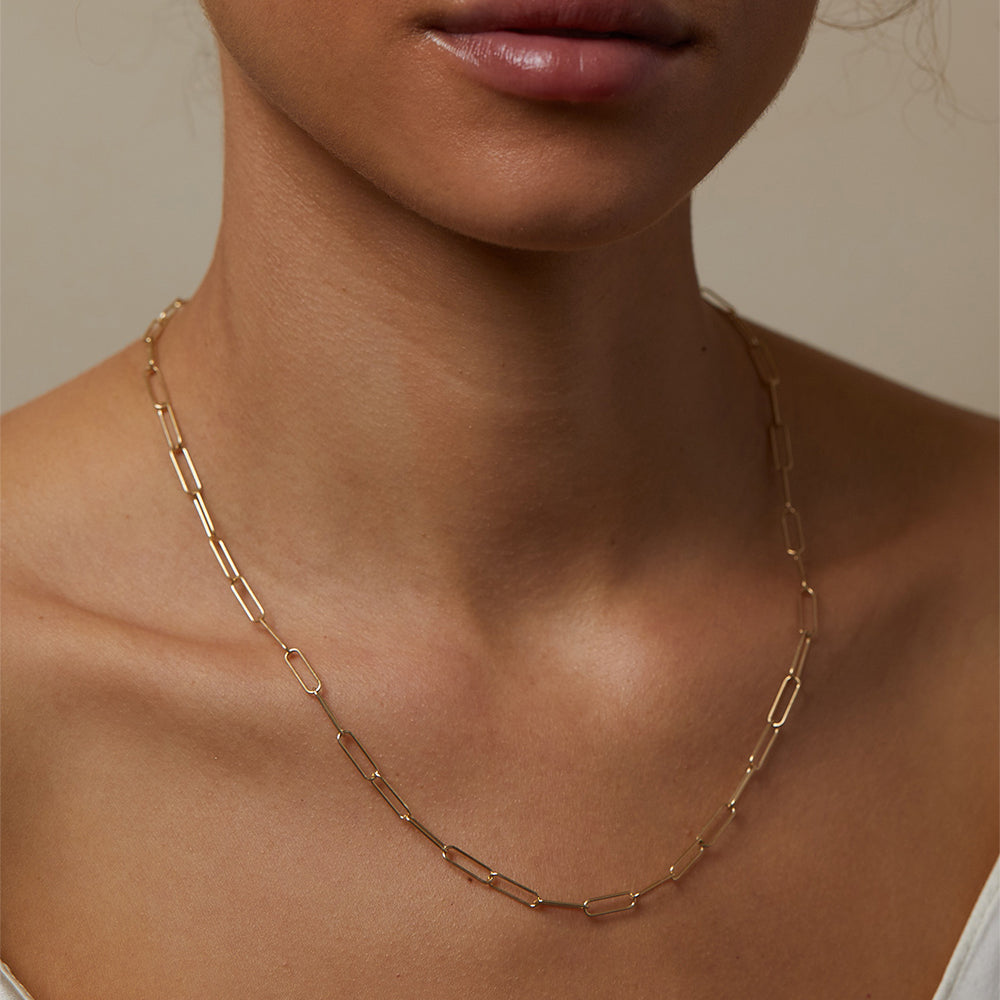 The Crush CN-C9 gold chain necklace with understated rectangular link design against skin