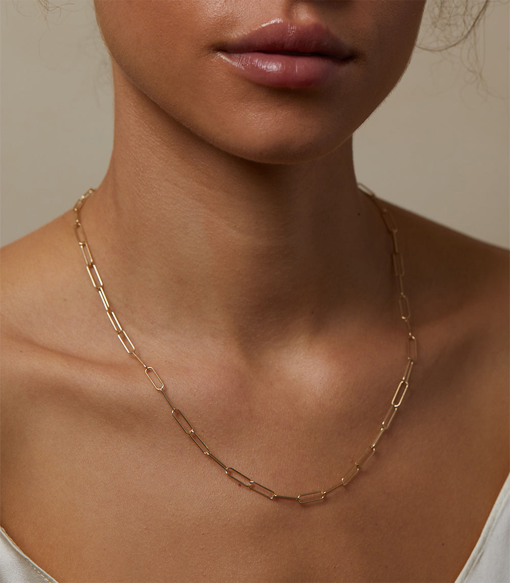 The Crush CN-C9 gold chain necklace with understated rectangular link design against skin