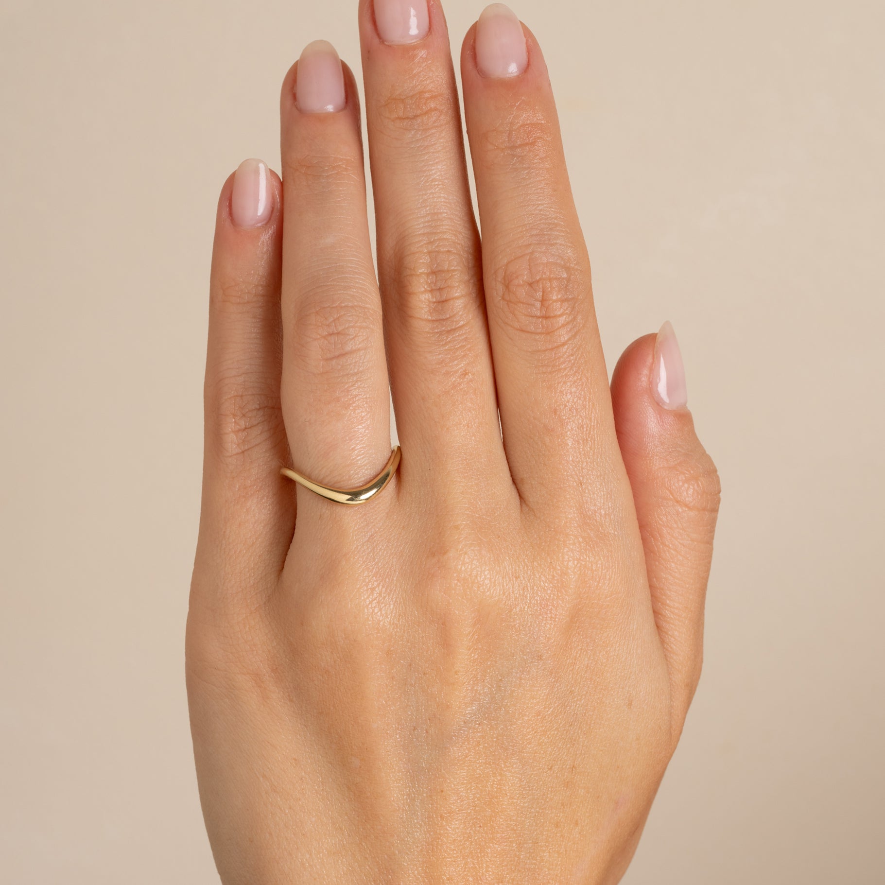 Medium Melt Band by EGB-R19 shiny yellow gold band ring with curved melt-edge detail on finger