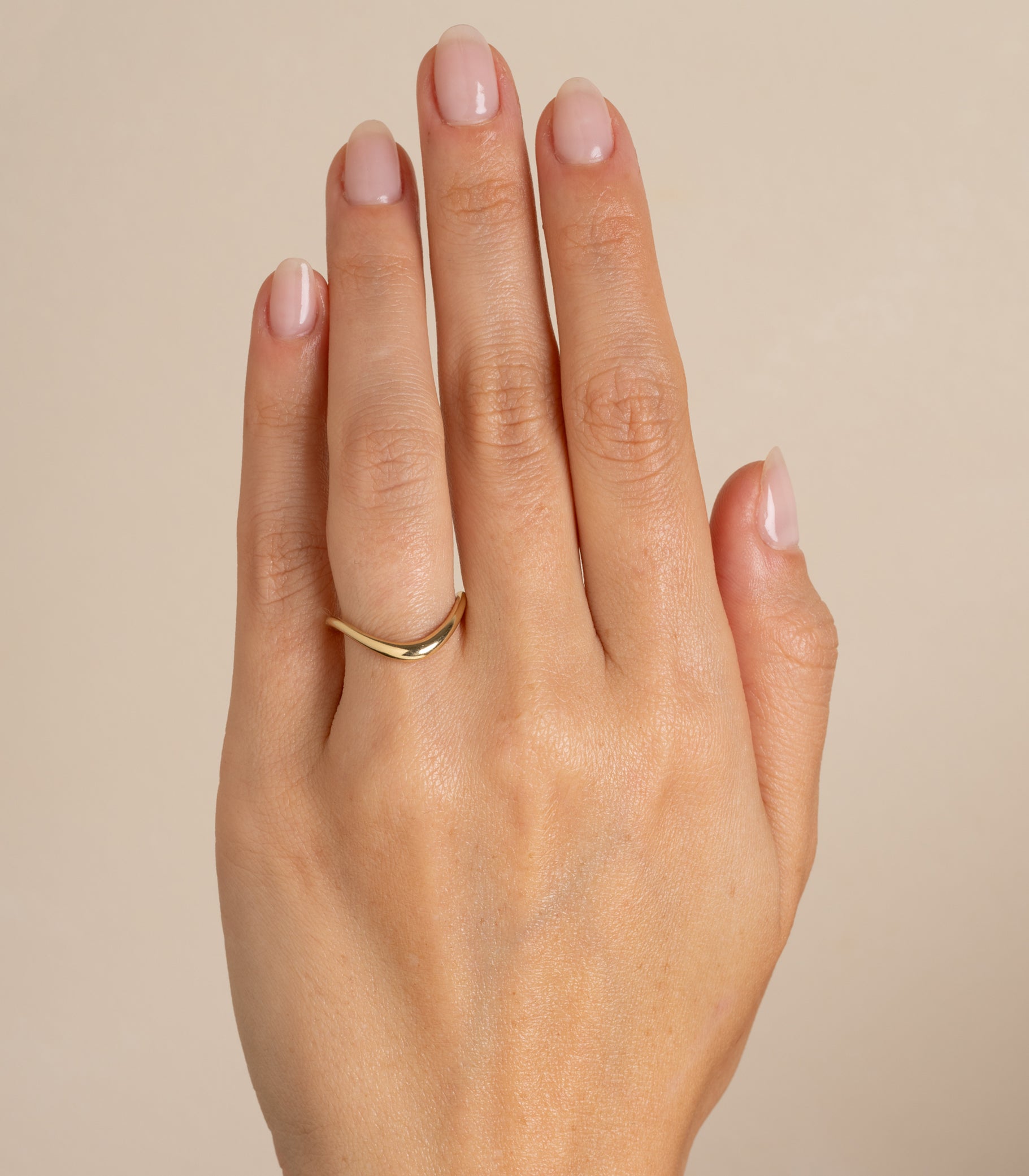 Medium Melt Band by EGB-R19 shiny yellow gold band ring with curved melt-edge detail on finger