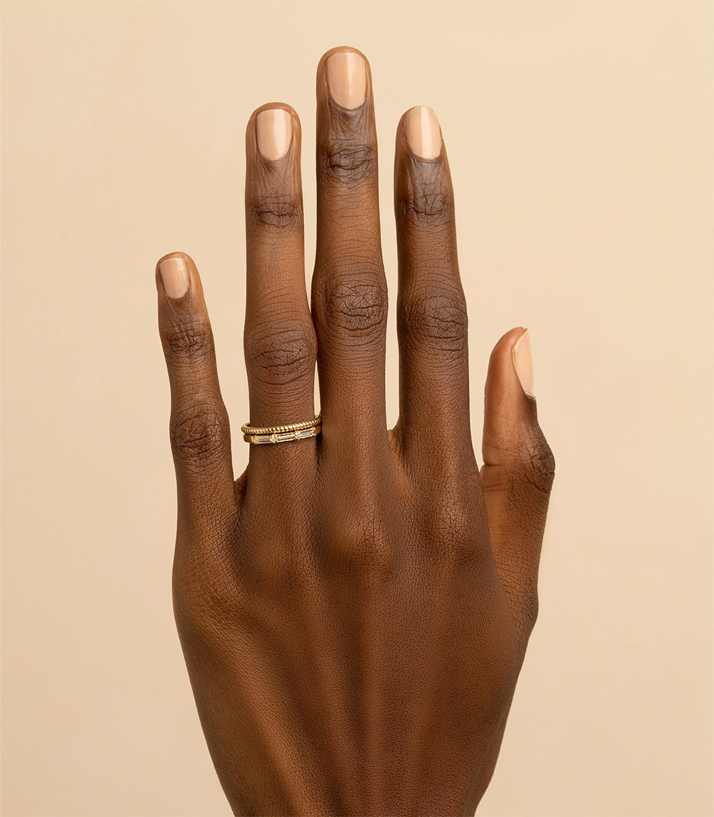 Tiny Coil Band A-R45 ring in shiny yellow gold with a tiny coiled band profile on finger