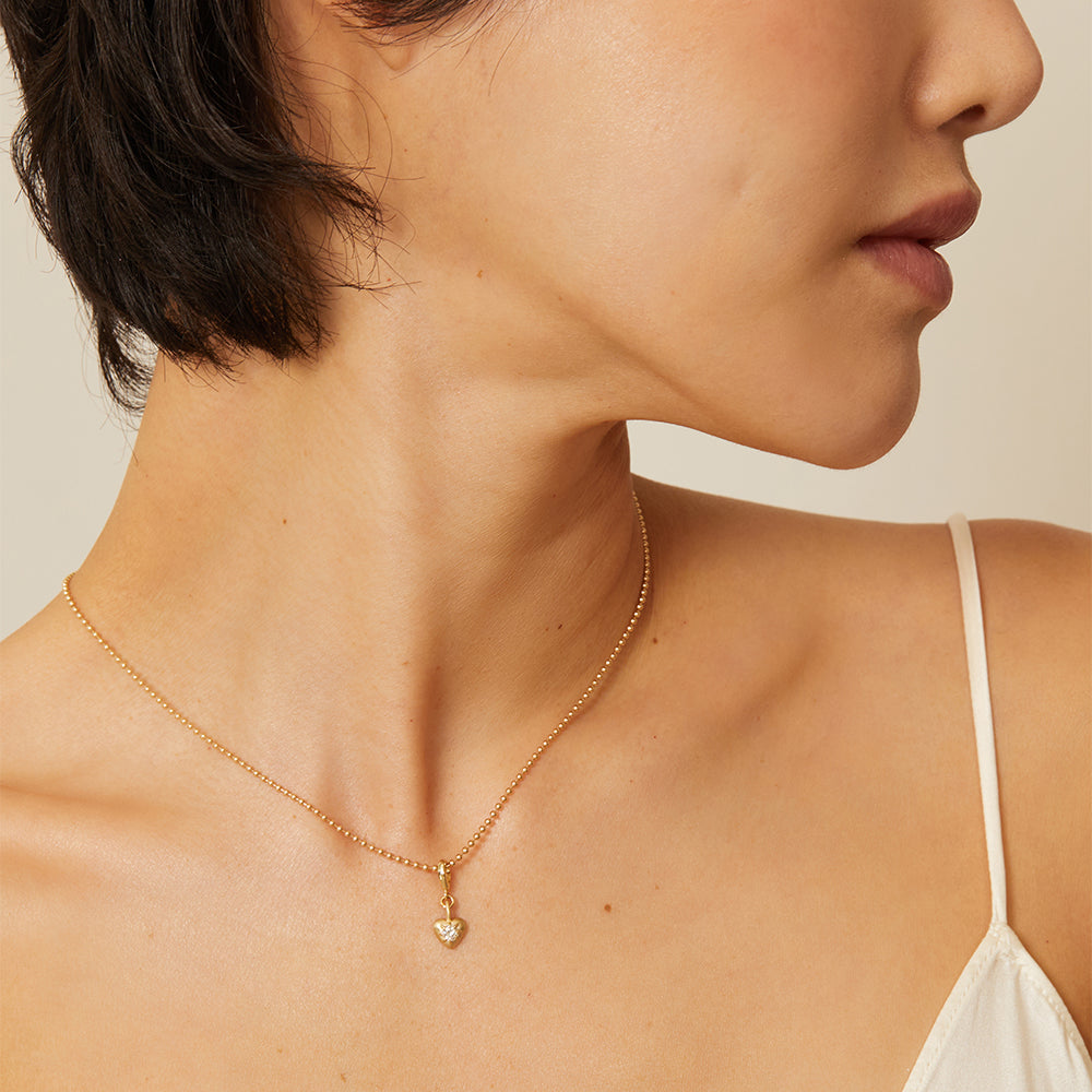 Cora Mini Charm KM-P10 shiny gold necklace with small heart charm on a delicate chain