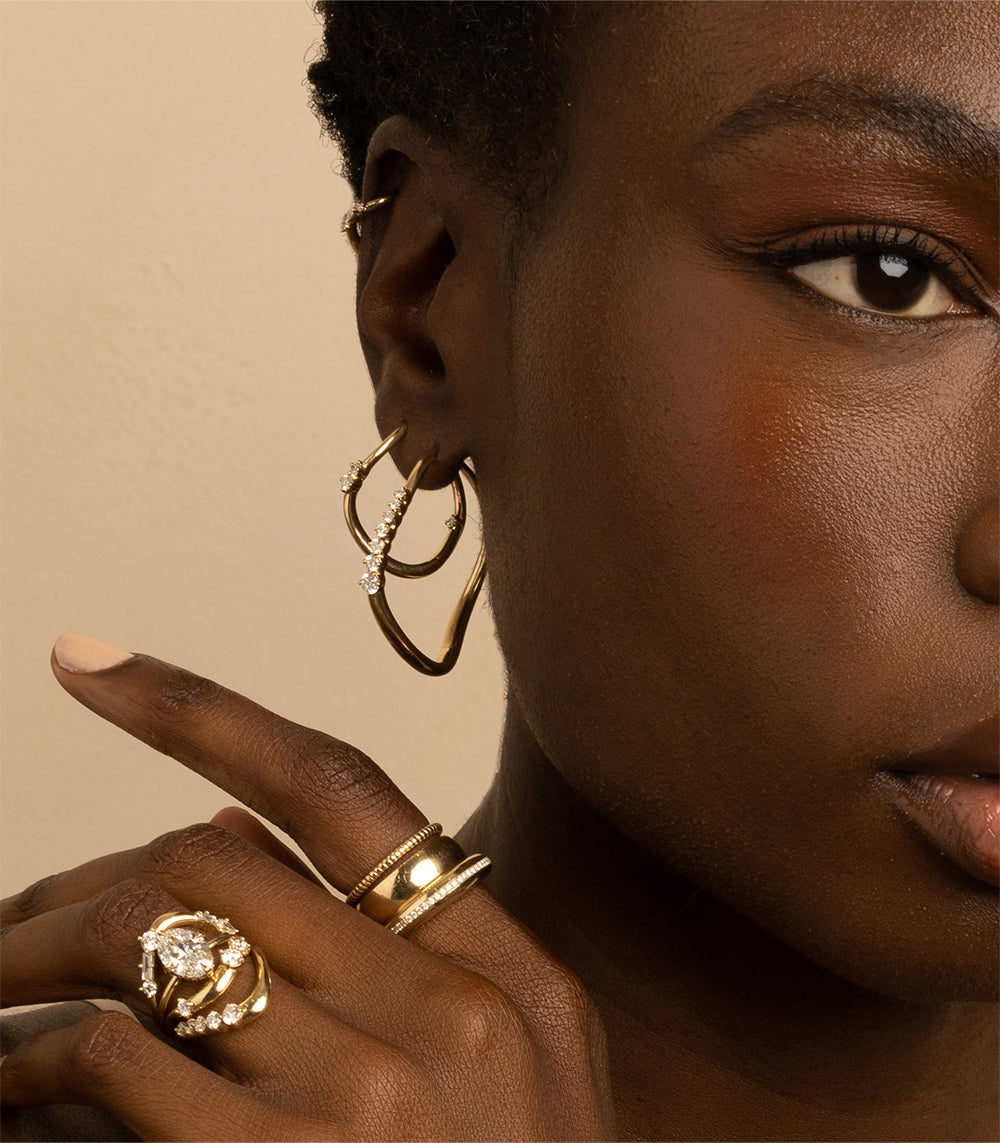 Medium Melt Hoops ML-E3 hoop earrings in gold with shiny and matte texture in warm studio light