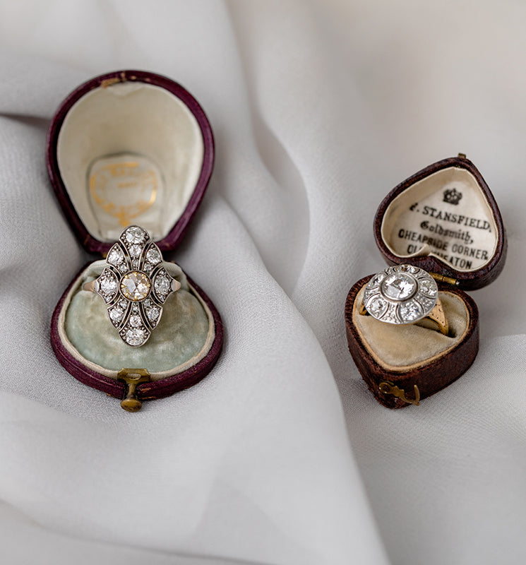 Unique engagement ring with clustered diamonds in an open velvet box, asymmetrical setting on the band