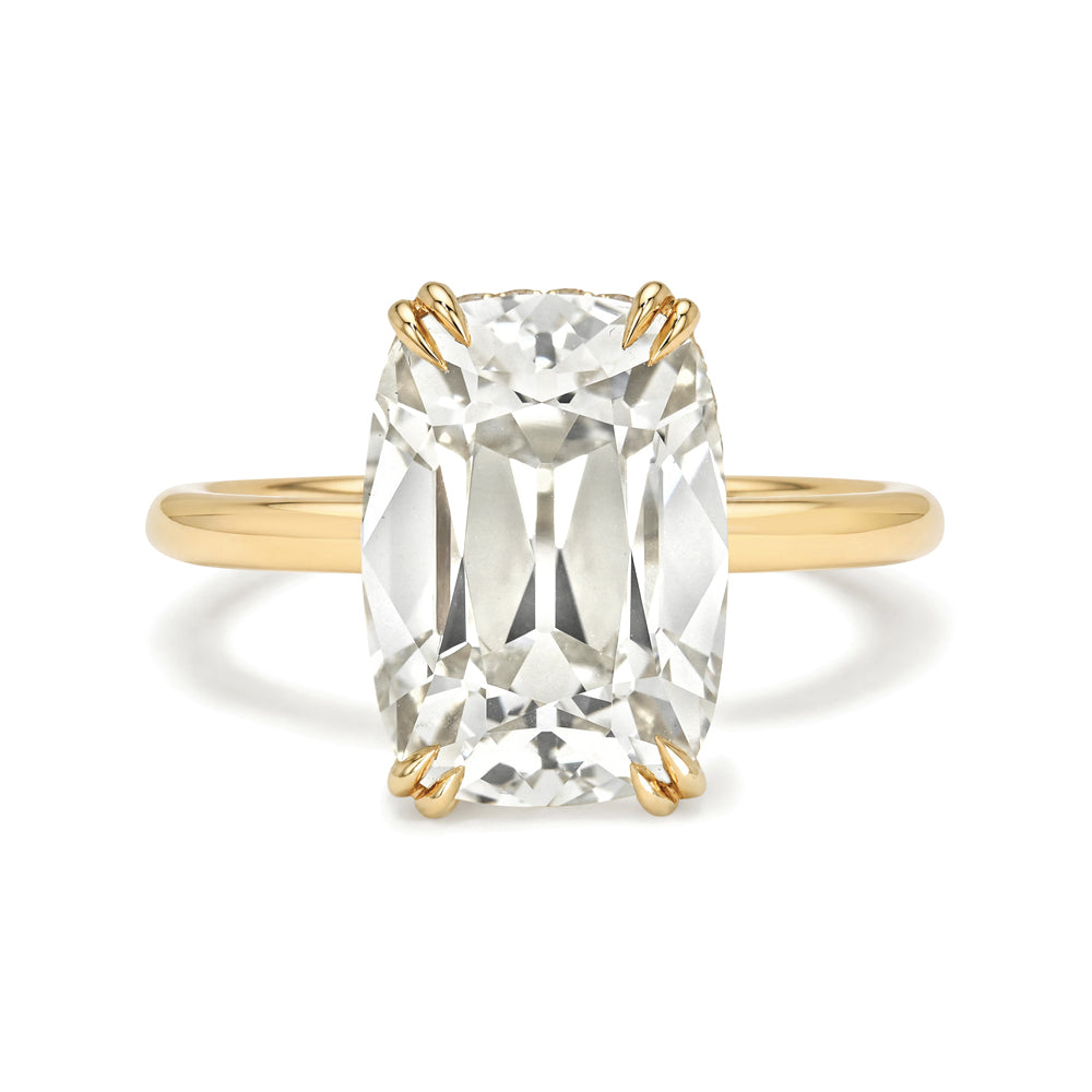 Gold ring with a large clear gemstone on a white background