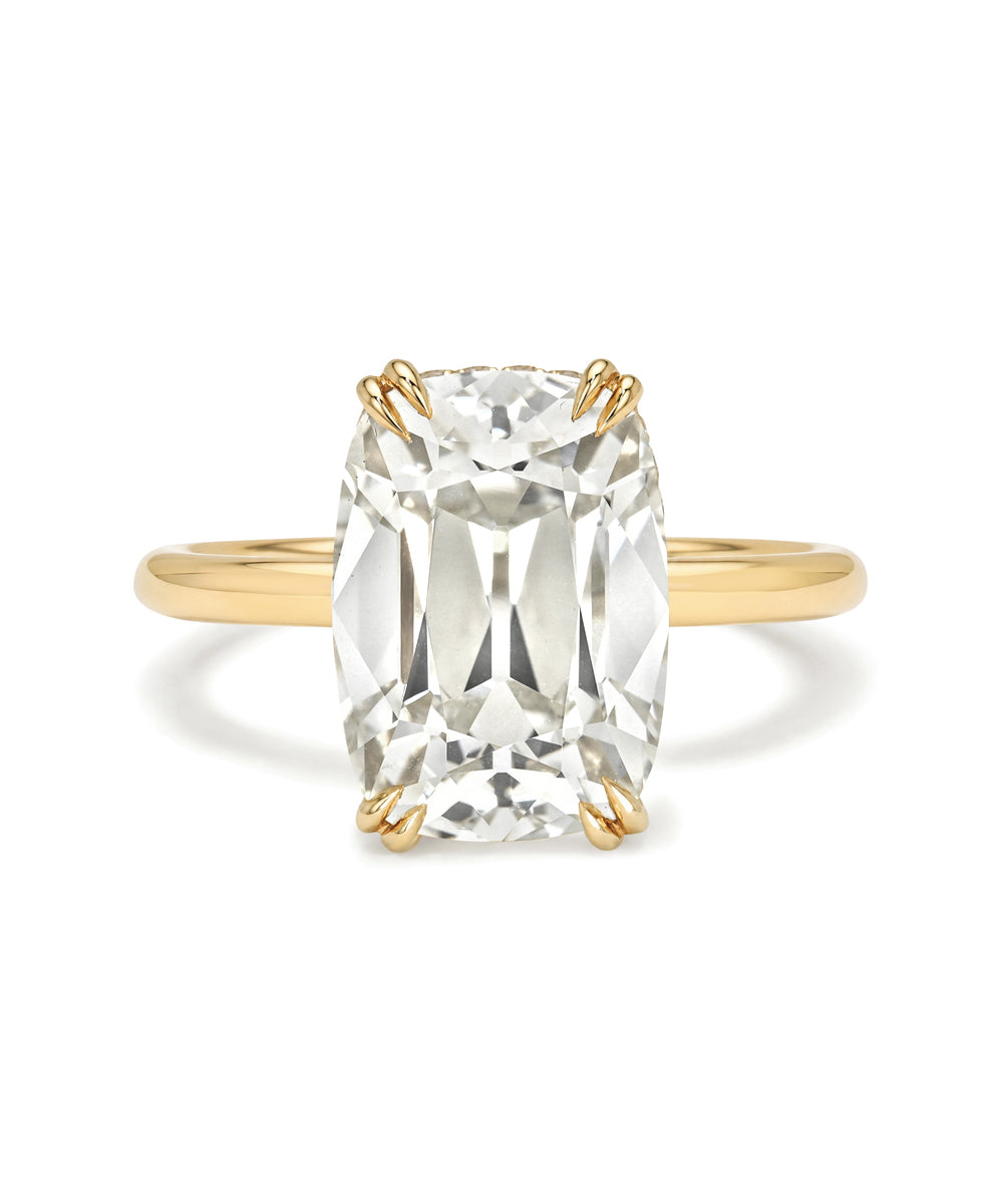 Gold ring with a large clear gemstone on a white background