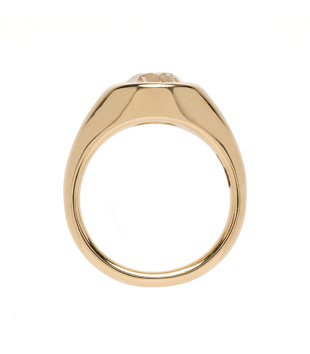 Isolde Sofia Kaman gold engagement ring with bezel-set clear stone on a smooth band