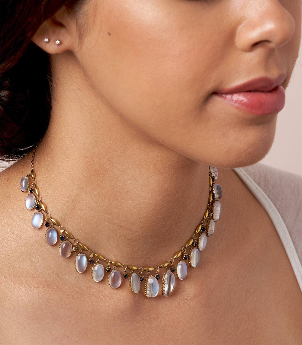 Moon Over Matter by VC-N36 gold necklace with oval opal-like stones, paired with small stud earrings